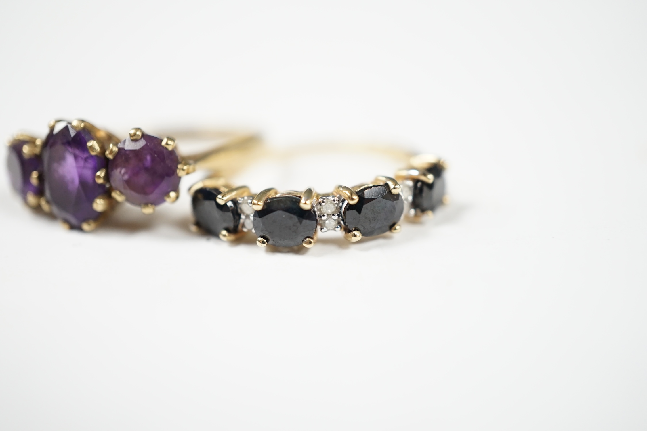 Two modern 9ct gold and gem set rings including three stone amethyst, size O and sapphire and diamond chip half hoop, gross weight 4.9 grams. Condition - fair